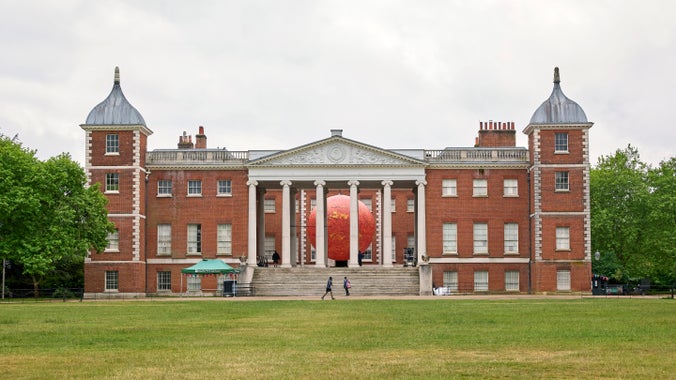 A view of Osterley House from the parkland with Luke Jerram's Helios visible between the coloumns of the portico